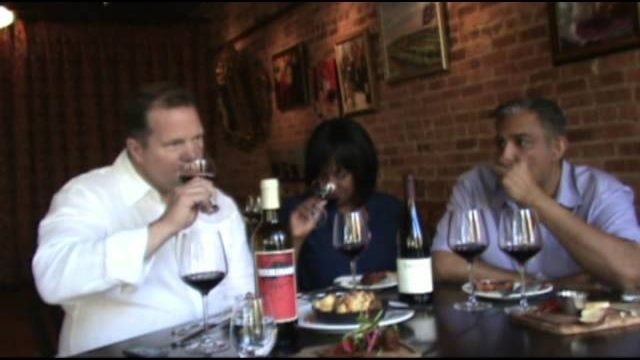 Guests tasting red blends with Jeff at a restaurant pairing dinner